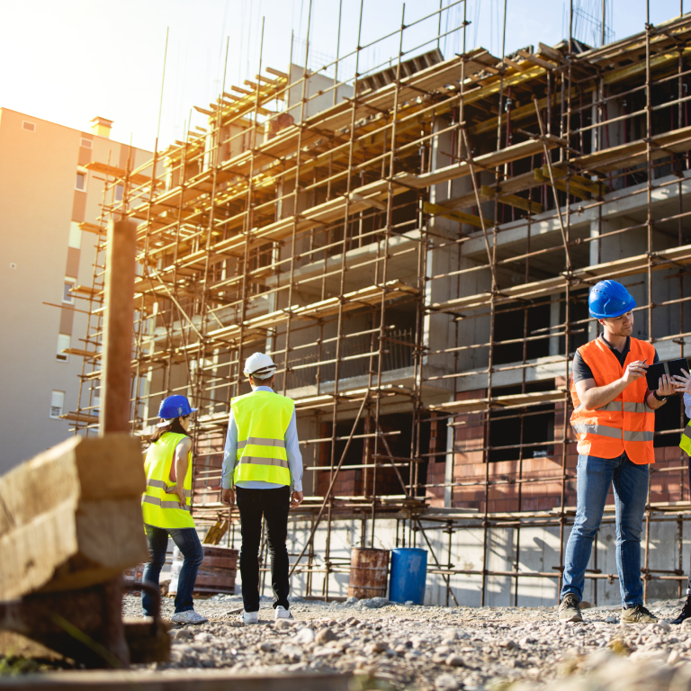 Four construction workers having meeting